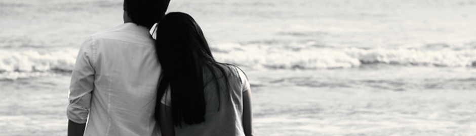 Young couple walking on beach